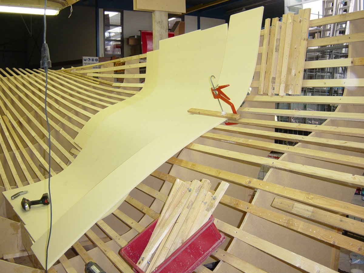 Starting the second main hull half by planking the form frames with vertical CoreCell foam strips