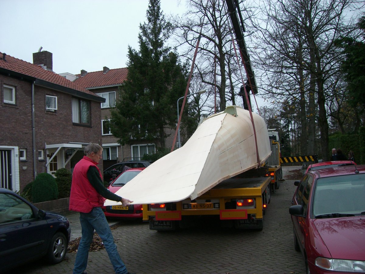 Lowering the starboard main hull half onto the transport trailer using a crane