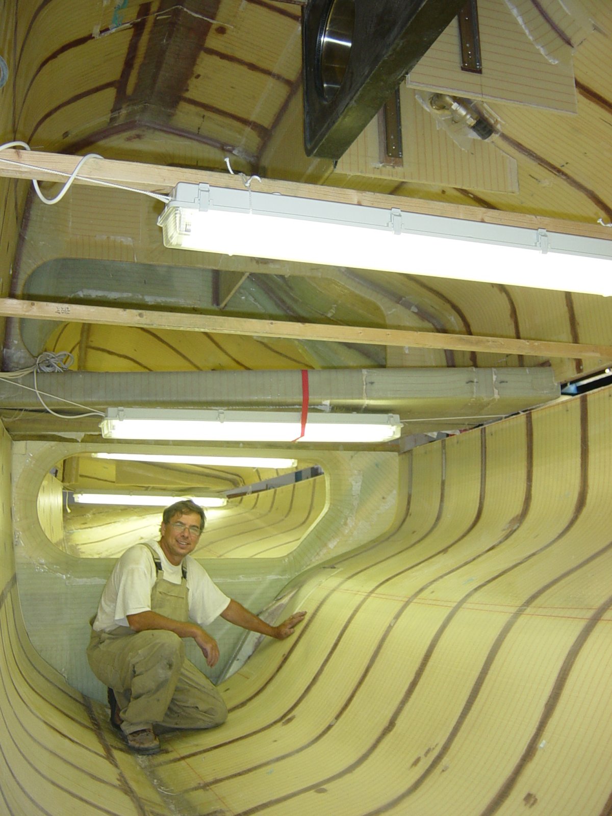 Port-side folding-system structure taking shape: carbon lower folding-strut anchor assemblies installed and beam bulkheads aligned in the hull