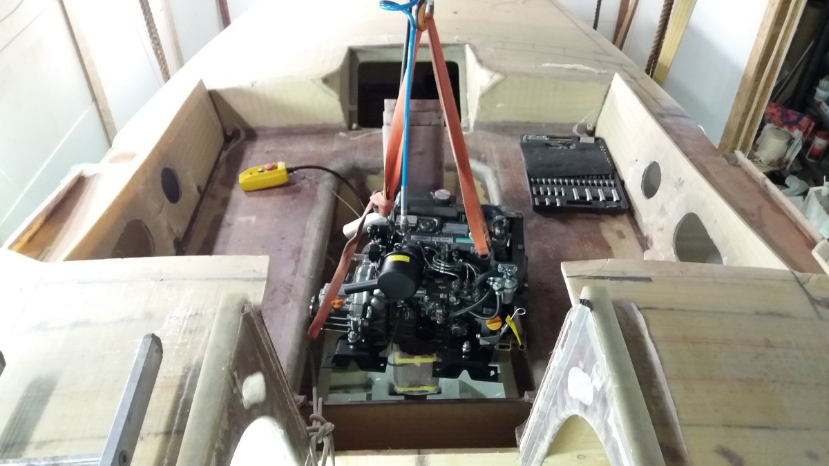 Lowering the Yanmar 3YM30 diesel engine through a temporary cockpit hatch during installation